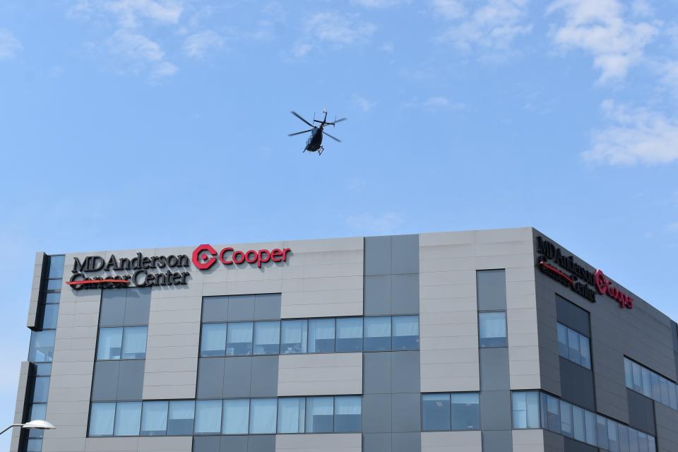 A helicopter flies over the MD Anderson Cancer Center at Cooper in Camden.