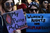 <p>Women hold placards reading “My pussy, my choice” and “Women’s rights are human rights” during a rally in solidarity with supporters of the Women’s March taking place in Washington and many other cities on January 21, 2017 in Lyon, southeastern France, one day after the inauguration of the president. (JEAN-PHILIPPE KSIAZEK/AFP/Getty Images) </p>