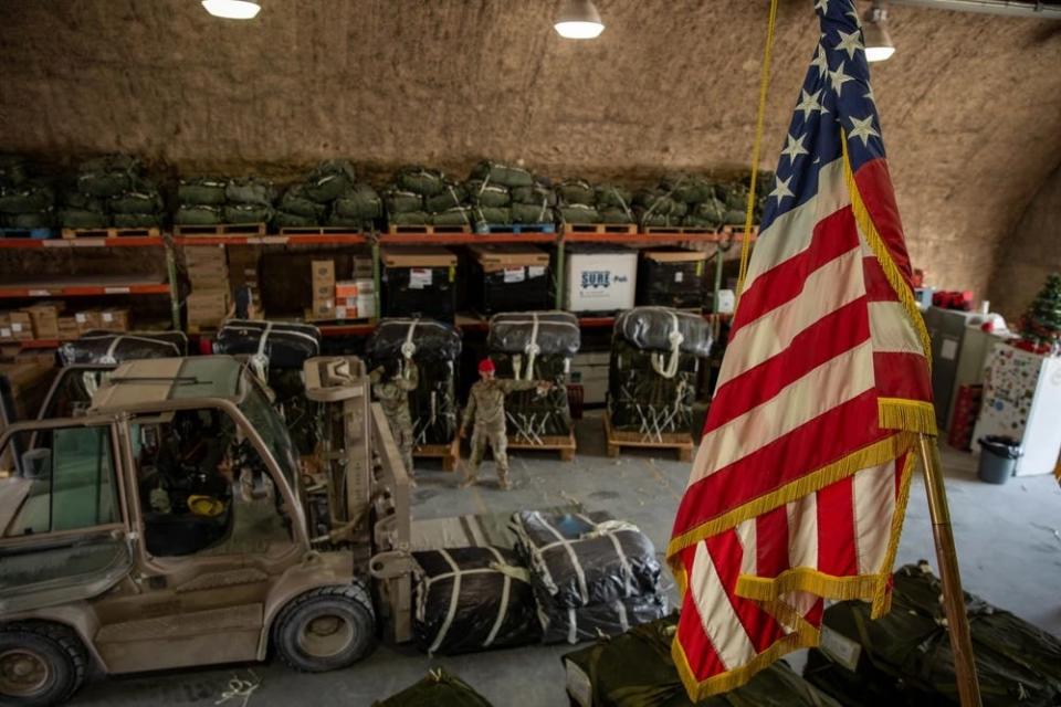 US service members prepare pallets of meals, ready-to-eat, and bottled water to be sent through humanitarian aid airdrops into Gaza.