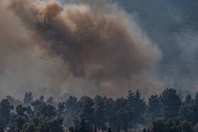 A fire erupts in a forest following a rocket hit from Lebanon on Safed. Ilia Yefimovich/dpa