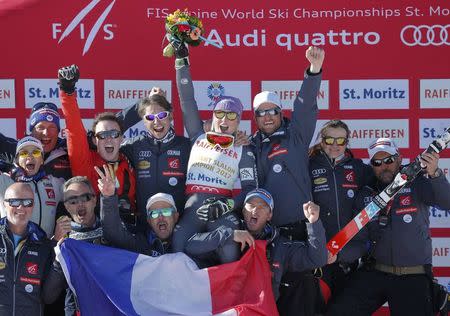 Alpine Skiing - FIS Alpine Skiing World Championships - Women's Giant Slalom - St. Moritz, Switzerland - 16/2/17 - Gold medalist Tessa Worley (C) of France celebrates with her team after the flower ceremony. REUTERS/Ruben Sprich