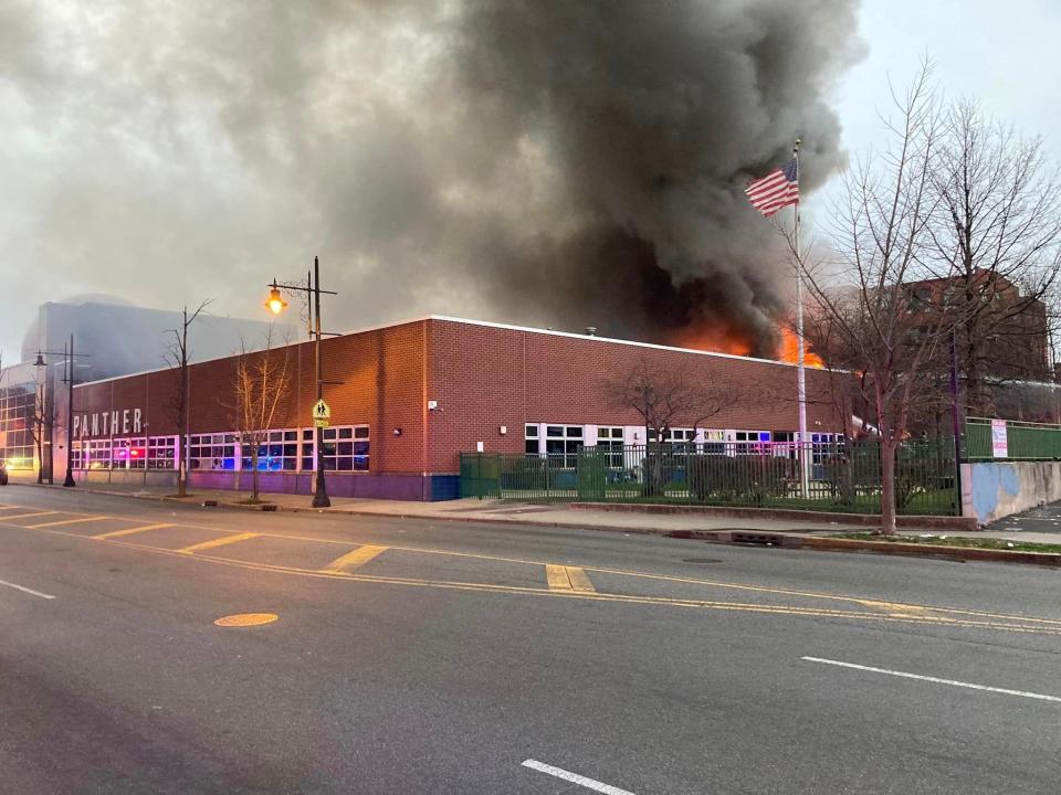 Flames and plums of smoke can be seen from the Pickle Factory, located behind the Panther Academy, a high school, in Paterson on Saturday morning, March 25, 2023.