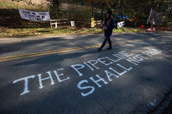 "This pipeline shall not pass" is spray painted on a road near a camp setup by protesters blocking the entrance to a trail on Burnaby Mountain where Kinder Morgan was preparing to start work for its Trans Mountain expansion project, Burnaby, B.C., Nov. 14, 2014.