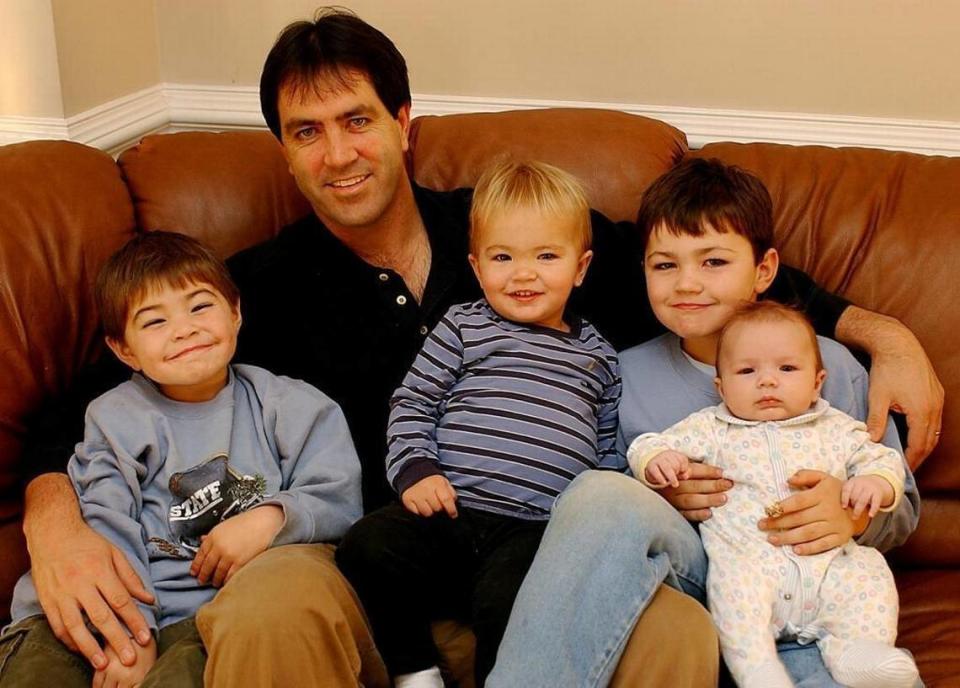 In 2002, Mark Maye posed for the Charlotte Observer with his four sons. The oldest brother, Luke, is holding the youngest brother, Drake, in the photo. File photo/Charlotte Observer