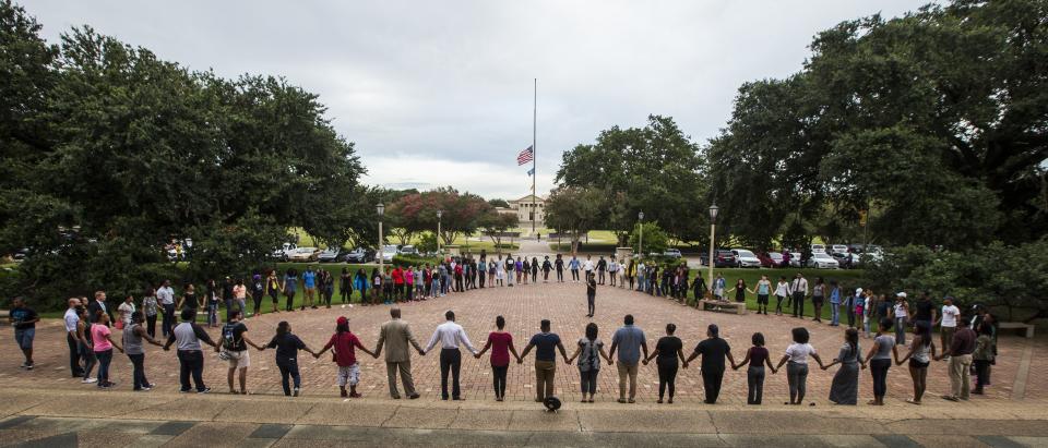 BATON ROUGE, LA -JULY 11:  Students gather at a prayer vigil for Alton Sterling at the Memorial Tower on the Louisiana State University campus July 11, 2016 in Baton Rouge, Louisiana. Sterling was shot by a police officer in front of the Triple S Food Mart in Baton Rouge on July 5th, leading the Department of Justice to open a civil rights investigation. (Photo by Mark Wallheiser/Getty Images)