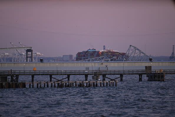 The steel frame of the Francis Scott Key Bridge sit on the water after it collapsed in Baltimore, Maryland, on March 26, 2024. The bridge collapsed after being struck by a container ship, sending multiple vehicles and up to 20 people plunging into the harbor below. 