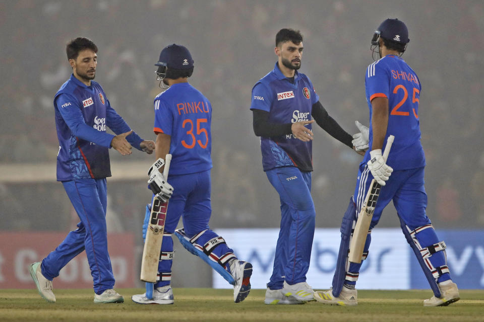 Afghanistans cricketers greet India's Shivam Dube, right and Rinku Singh at the end of the first T20 cricket match between India and Afghanistan in Mohali, India, Thursday, Jan. 11, 2024. (AP Photo/Surjeet Yadav)