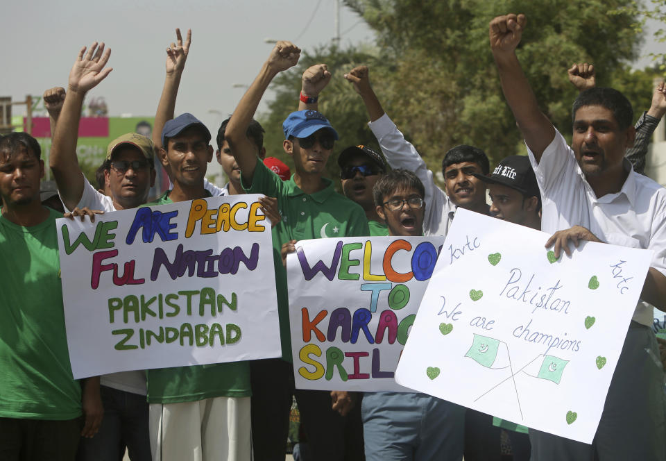 Pakistani cricket fans celebrate the Pakistan--Sri Lanka cricket series outside the National stadium in Karachi, Pakistan, Monday, Sept. 30, 2019. Karachi's 10-year long wait to host a one-day international finally ended on Monday as Pakistan won the toss and elected to bat against Sri Lanka in the second ODI. (AP Photo/Fareed Khan)