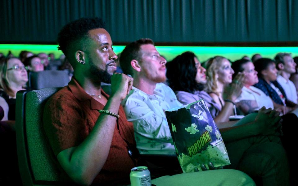 Keith Churn left and and Connor Moss watch the opening scenes of the HBO ÒWe're HereÓ Season 4 Premiere during a RuCo Pride watch party at Premiere 6, in Murfreesboro, Tenn., on Friday, April 26, 2024.