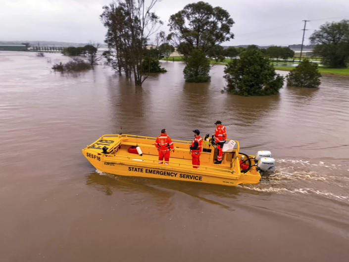 In this photo provided by the State Emergency Service, a boat patrols the Hunter River near Hinton, Australia, Wednesday, July 6, 2022. Floodwaters were receding in Sydney and its surrounds on Thursday, July 7, 2022, as heavy rain continued to threaten to inundate towns north of Australia's largest city. (State Emergency Service via AP)