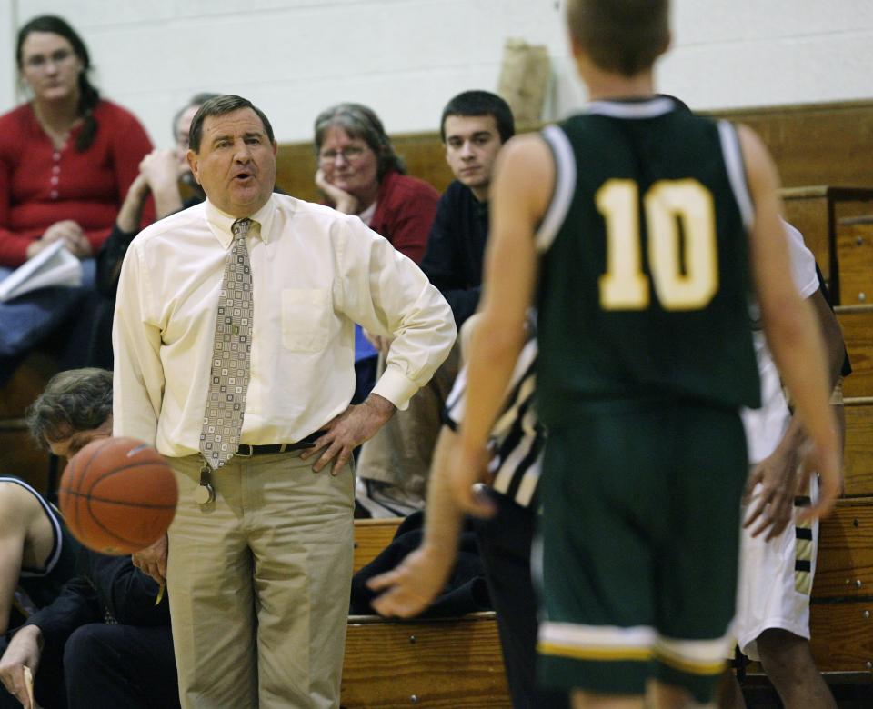 Lee Sibley instructs a Saint Mark's player in a 2008 game.