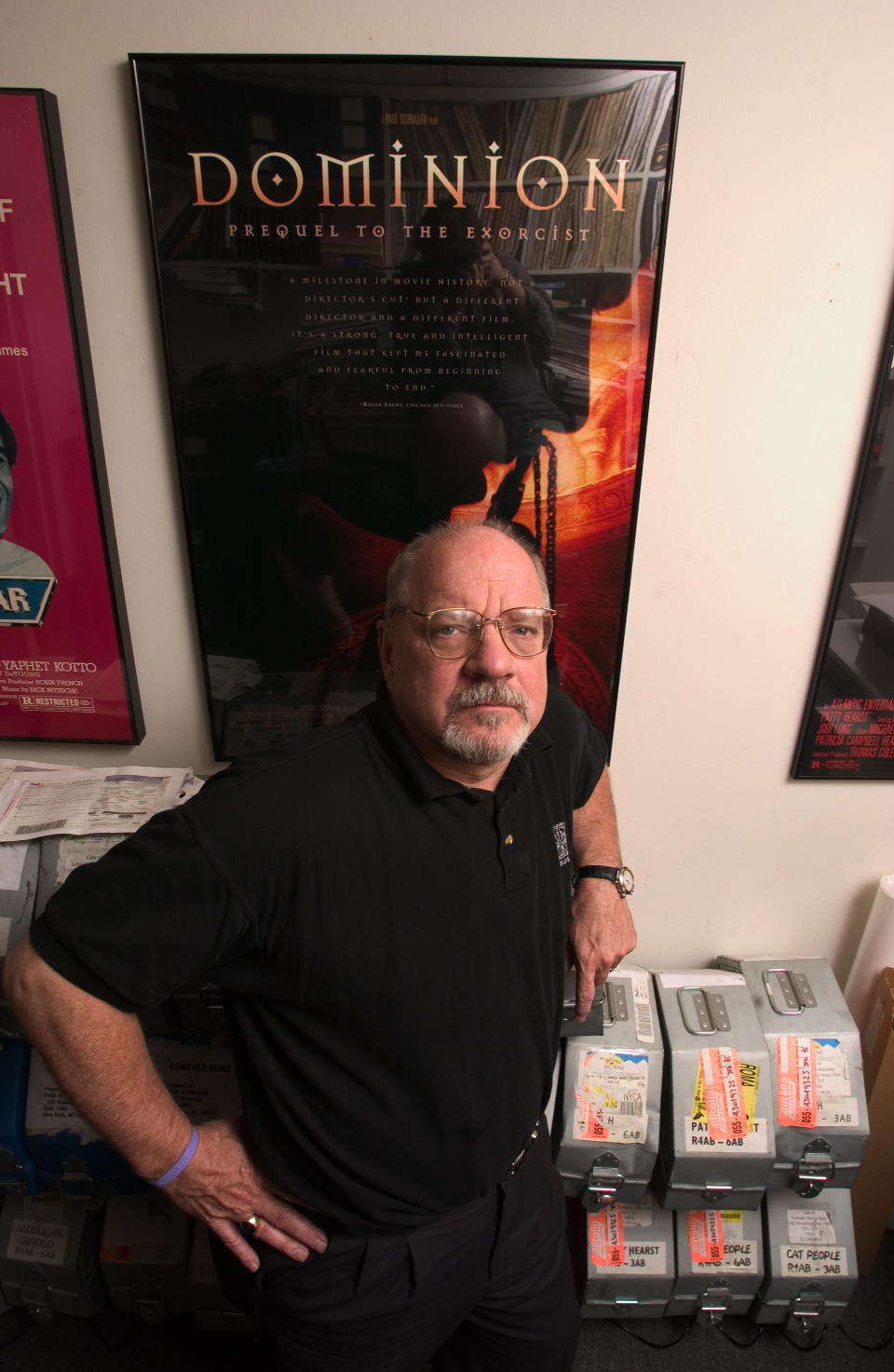 Director and screenwriter Paul Schrader is photographed  in his New York office May 17, 2005, with a poster for his film "Dominion Prequel to the Exorcist" on the wall behind him.  (AP Photo/Jim Cooper)