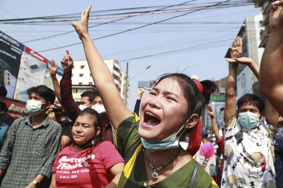 A protester shouts as she flashes the three-fingered salute during a protest rally in Yangon, Myanmar, on Feb. 6, 2021. Protests in Myanmar against the military coup that removed Aung San Suu Kyi’s government from power have grown in recent days despite official efforts to make organizing them difficult or even illegal. (AP Photo)