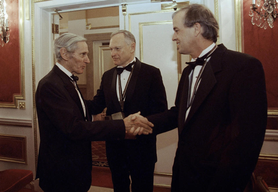 FILE - In this Nov. 16, 1994, file photo, The National Book Awards prize winning writers, William Gaddis, left, Sherwin B. Nuland, center, and James Tate greet each other after the awards ceremony in New York. Nuland, the author of 1994 National Book Award winner "How We Die," has died at age 83. Nuland died of prostate cancer on Monday, March 3, 2014, at his home in Hamden, said his daughter Amelia Nuland, who recalled how he told her he wasn't ready for death because he loved life. (AP Photo/Adam Nadel, File)