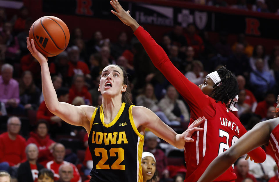 Iowa guard Caitlin Clark (22) drives to the basket against Rutgers guard Erica Lafayette (20) during the first half of an NCAA college basketball game Friday, Jan. 5, 2024, in Piscataway, N.J. (AP Photo/Noah K. Murray)