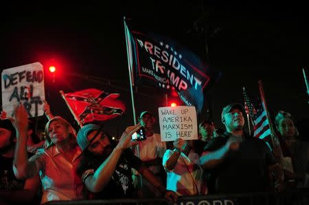 Protesters demonstrate as a construction crew works to remove a monument of Confederate General P.G.T. Beauregard at the entrance to City Park in New Orleans, Louisiana, U.S. May 16, 2017. REUTERS/Cheryl Gerber