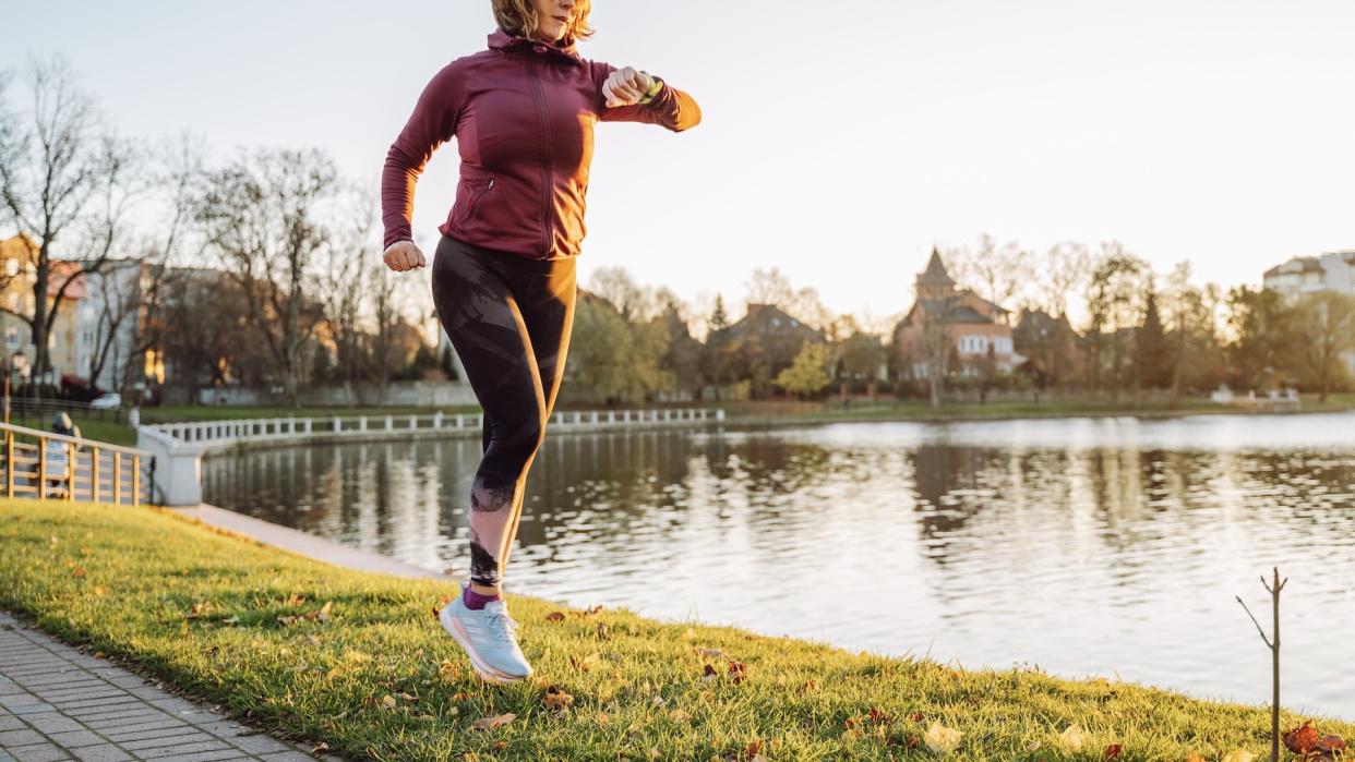  Woman running with sports watch. 