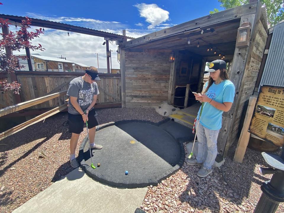 Abigale Beeler (left) and Ally Caldwell play a round of mini golf at Copper River in Pueblo West.