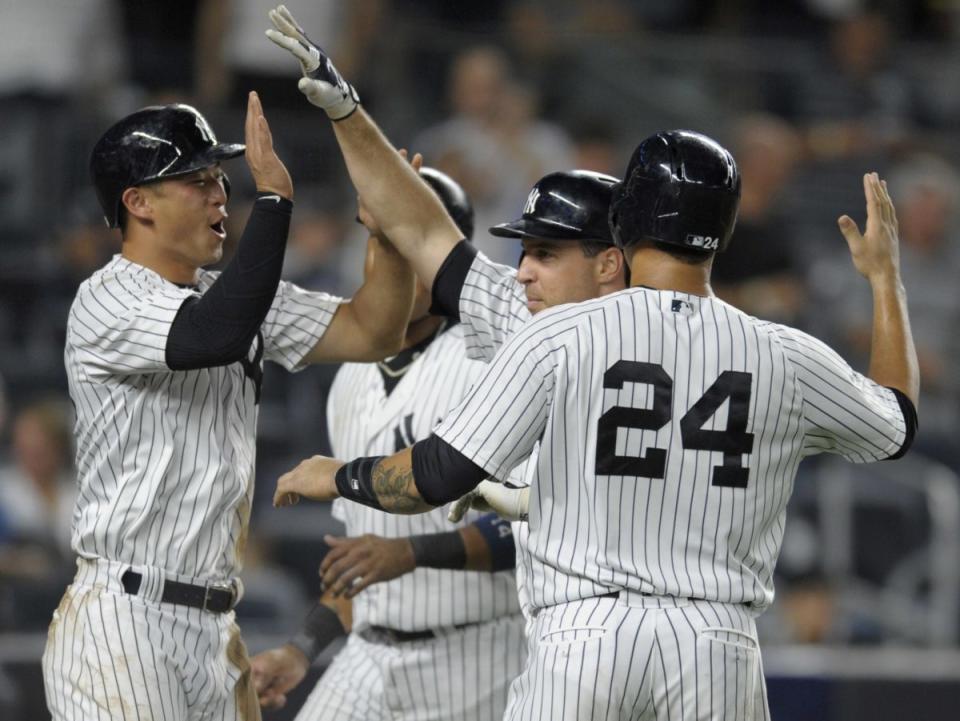 Mark Teixeira is welcomed home after his 11th career grand slam. (AP)