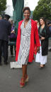 <p>The athlete put her most fashionable foot forward in a stripy wrap dress and contrasting coat. <i>[Photo: PA Images]</i></p>