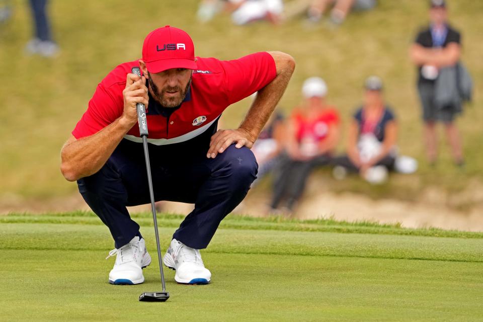 Sep 26, 2021; Haven, Wisconsin, USA; Team USA player Dustin Johnson lines up his putt on the first hole during day two four-ball rounds for the 43rd Ryder Cup golf competition at Whistling Straits. Mandatory Credit: Kyle Terada-USA TODAY Sports
