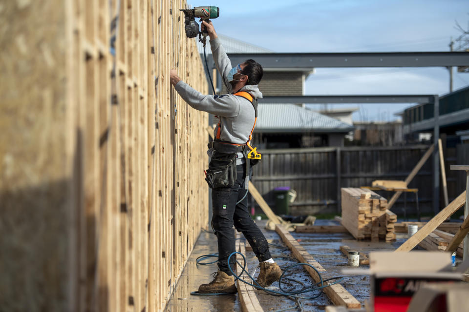 A builder works a on a construction site during lockdown due to the continuing spread of the coronavirus in Melbourne, Thursday, Aug. 6, 2020. Victoria state, Australia's coronavirus hot spot, announced on Monday that businesses will be closed and scaled down in a bid to curb the spread of the virus. (AP Photo/Andy Brownbill)