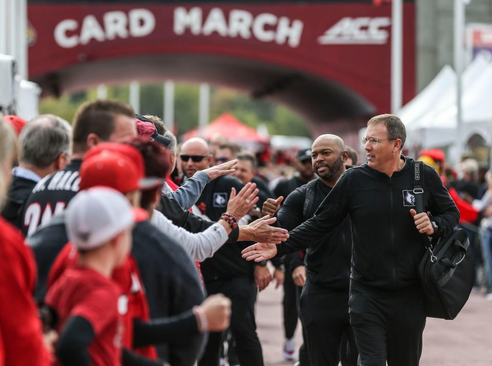 Louisville head football coach Scott Satterfield greet fans during the Cardmarch before the game against Boston College Saturday at Cardinal Stadium. Oct. 23, 2021