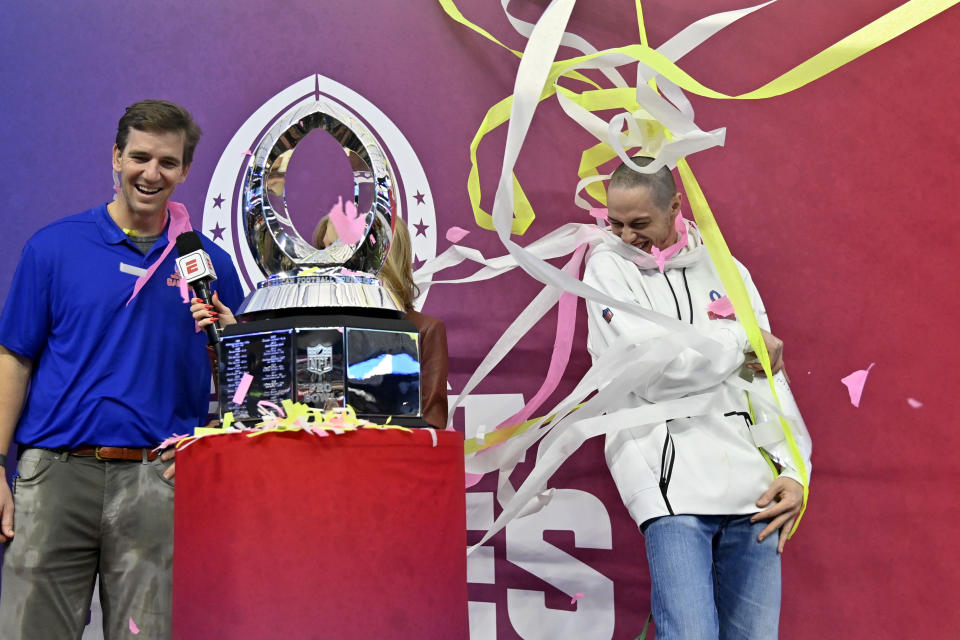 NFC captain Pete Davidson, right, reacts as he stands next to head coach Eli Manning and the trophy after the NFC defeated AFC at the NFL Pro Bowl games, Sunday, Feb. 5, 2023, in Las Vegas. (AP Photo/David Becker)