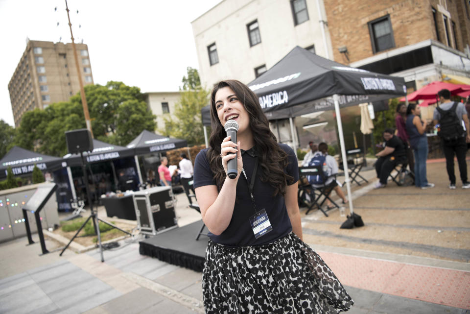 Reporter Jenna Amatulli uses the microphone to&nbsp;speak to passersby.