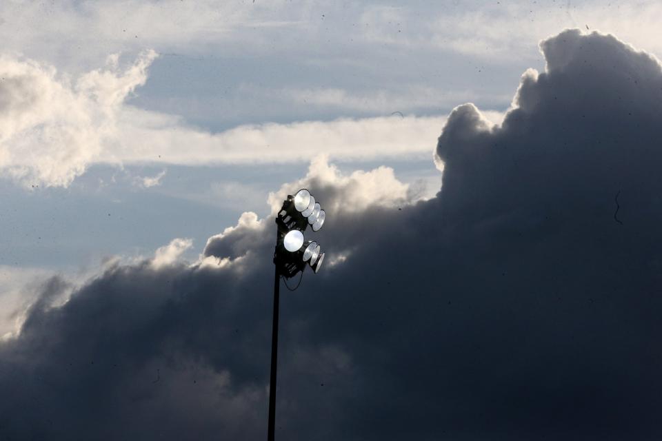 Dark clouds shrouds stadium lights at Perry High School during the Federal League Track and Field Championships at Perry in May.