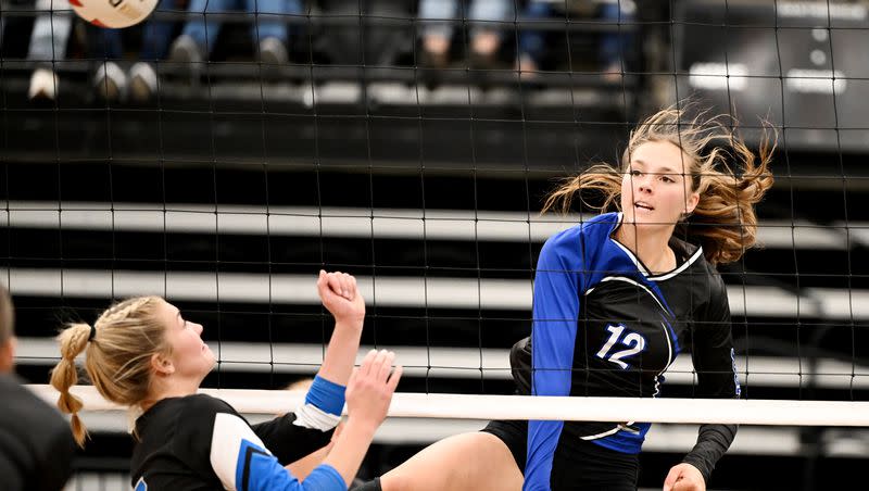 Panguitch’s Tabetha Henrie spikes the ball over Rich’s Aeva Ellsworth as they play for the 1A state volleyball championship at UVU on Saturday, Oct. 28, 2023.