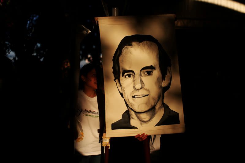 FILE PHOTO: Students hold a portrait of Jesuit priest Ignacio Ellacuria prior to a procession in San Salvador