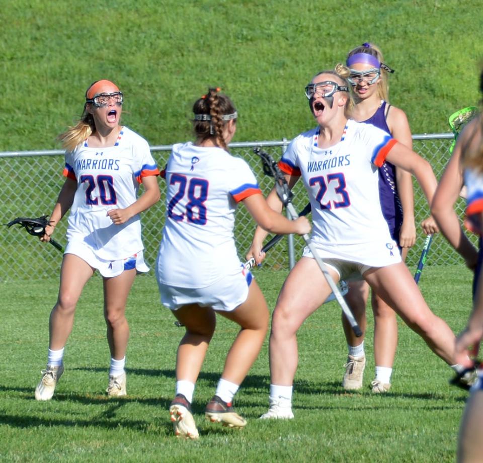 Boonsboro's Micah Stine (23) lets out a yell as she celebrates her goal with teammates Hanna Santora (28) and Lexie Wilt (20) during the first half of the Class 1A West Region II girls lacrosse final against Smithsburg on May 16. The Warriors defeated the Leopards 13-8 to earn a spot in the state quarterfinals.