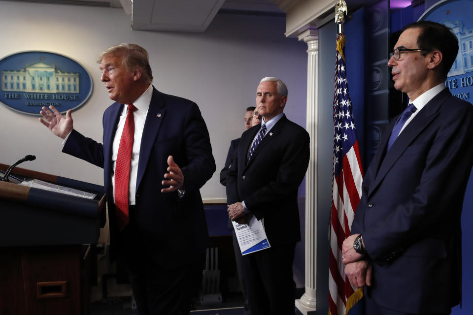 President Donald Trump speaks about the coronavirus in the James Brady Briefing Room, Wednesday, March 25, 2020, in Washington as Vice President Mike Pence and Treasury Secretary Steven Mnuchin listen. (AP Photo/Alex Brandon)