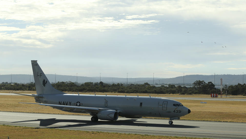 A U.S. Navy P-8 Poseidon taxies along the runway before it takes off from Perth Airport on route to rejoin the on-going search operations for the missing Malaysia Airlines Flight 370 in Perth, Australia, Thursday, April 10, 2014. Planes and ships hunting for the missing Malaysian jetliner zeroed in on a targeted patch of the Indian Ocean on Thursday, after a navy ship picked up underwater signals that are consistent with a plane's black box. (AP Photo/Rob Griffith)