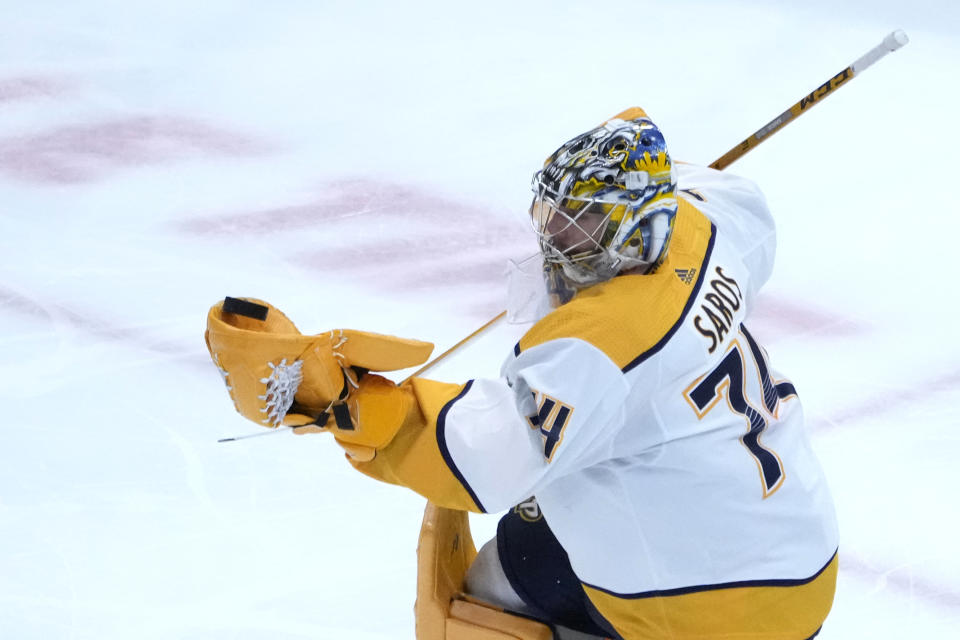 Nashville Predators goaltender Juuse Saros makes a glove-save during the second period of an NHL hockey game against the Chicago Blackhawks, Saturday, March 4, 2023, in Chicago. (AP Photo/Charles Rex Arbogast)