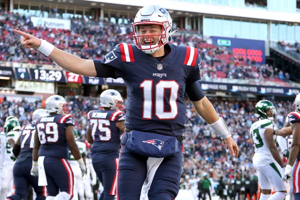 Mac Jones #10 of the New England Patriots celebrates after a touchdown f in the game