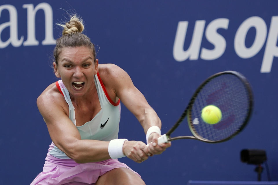 FILE - Simona Halep, of Romania, returns a shot to Daria Snigur, of Ukraine, during the first round of the U.S. Open tennis championships Aug. 29, 2022, in New York. Two-time Grand Slam champion Simona Halep has been suspended from professional tennis for four years for alleged doping violations, the International Tennis Integrity Agency said Tuesday, Sept. 12, 2023. (AP Photo/Seth Wenig, File)