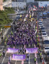 People march together before a rally to mark the first anniversary of the harrowing crowd surge that killed about 160 people in a Seoul alleyway, in Seoul, South Korea, Sunday, Oct. 29, 2023. (AP Photo/Ahn Young-joon)