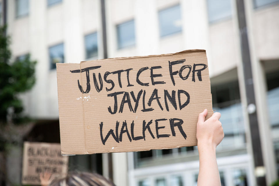 A protester holds a sign reading: Justice for Jayland Walker.