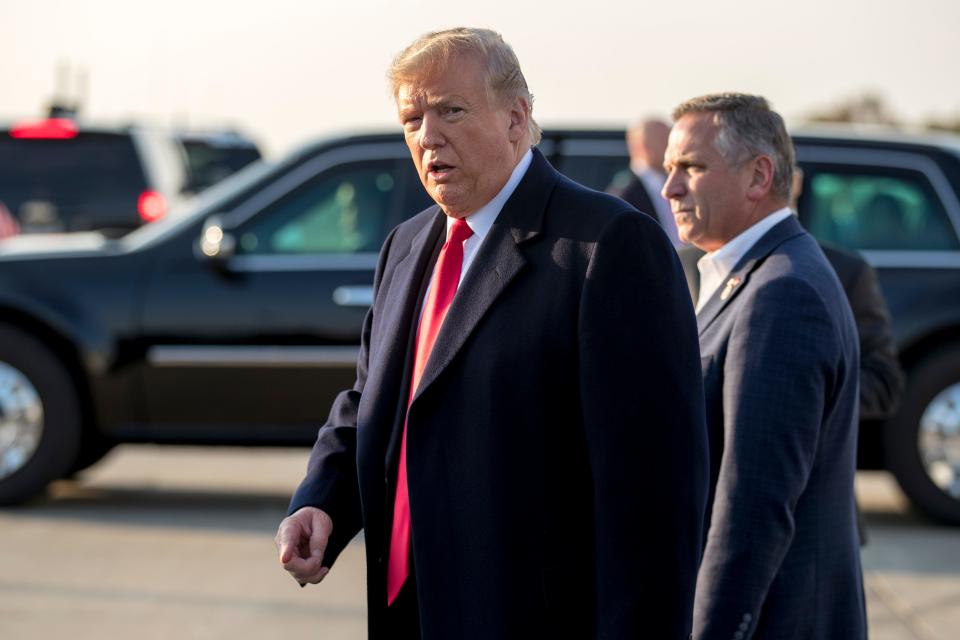 President Donald Trump is greeted by Rep. Mike Bost, R-Ill., right, as he arrives at Southern Illinois Airport in Murphysboro, Ill., Oct. 27, 2018, for a rally.