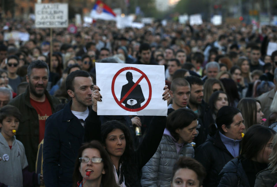 A protester holds a banner shows Serbian Prime Minister Aleksandar Vucic during a protest march in Belgrade, Serbia, Sunday, April 9, 2017. Thousands of people have protested for the seventh consecutive day against the presidential election victory of Serbia's powerful Prime Minister Aleksandar Vucic, amid fresh allegations by the opposition of a rigged vote count. (AP Photo/Darko Vojinovic)