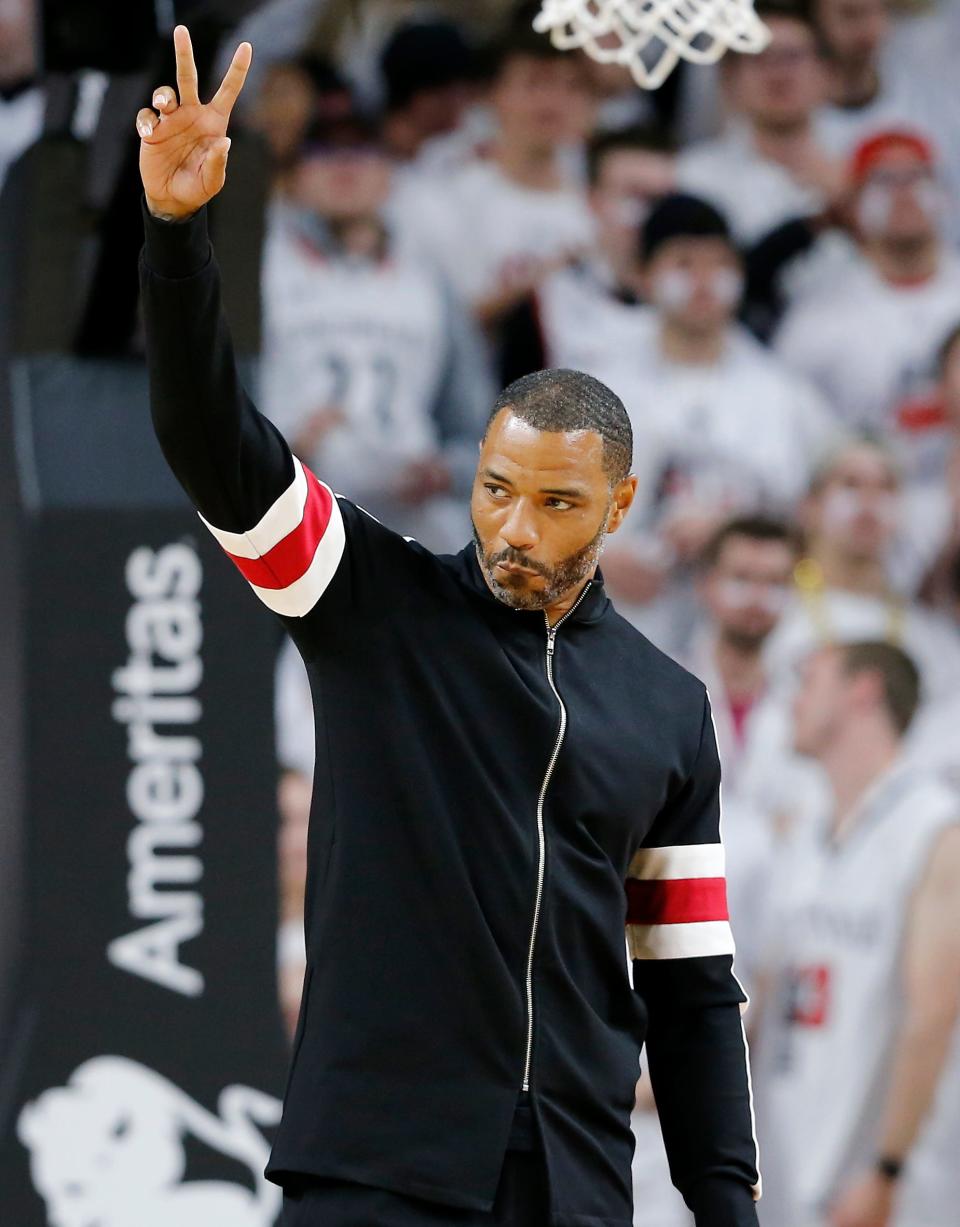 Former Bearcats great Kenyon Martin waves to the fans as he's introduced before the first half of the NCAA basketball game between the Cincinnati Bearcats and the Ohio State Buckeyes at Fifth Third Arena in Cincinnati on Wednesday, Nov. 7, 2018. The Buckeyes led 27-18 at halftime. 