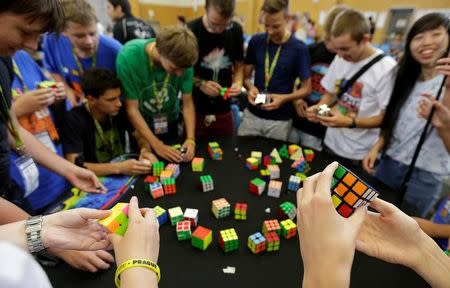 Competitors solve Rubik's cubes as they prepare for the Rubik's Cube European Championship in Prague, Czech Republic, July 17, 2016. REUTERS/David W Cerny