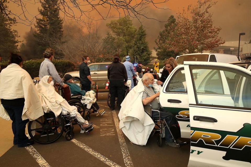 Hospital workers and first responders evacuate patients from the Feather River Hospitalduring Camp Fire on Nov. 8