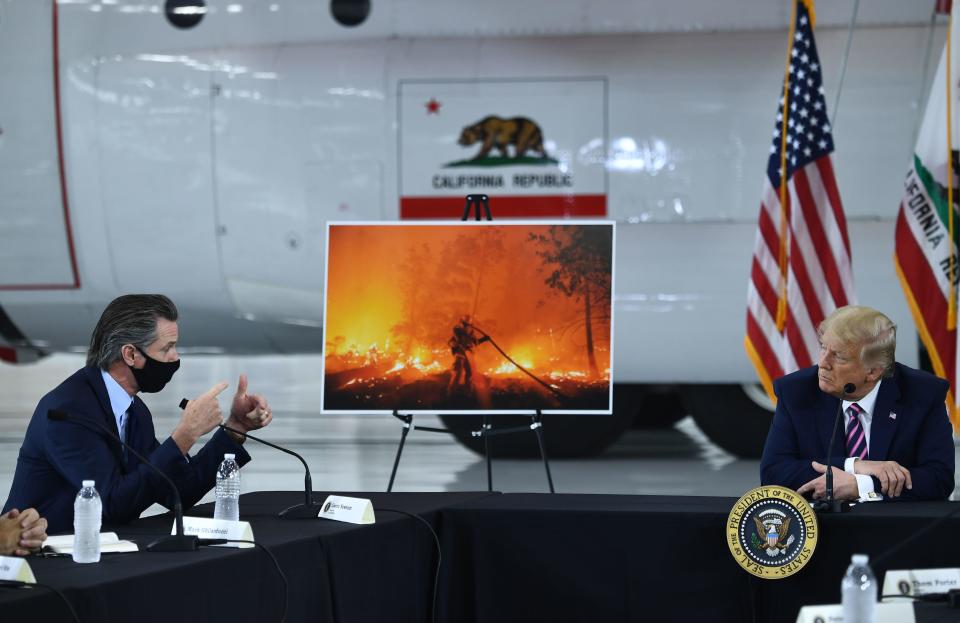 President Donald Trump speaks to California Governor Gavin Newsom at Sacramento McClellan Airport on September 14, 2020 during a briefing on wildfires. / Credit: BRENDAN SMIALOWSKI/AFP via Getty Images