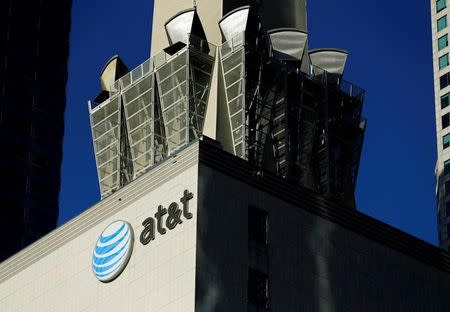 FILE PHOTO: An AT&T logo and communication equipment is shown on a building in downtown Los Angeles, California October 29, 2014. REUTERS/Mike Blake/File Photo