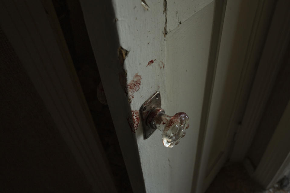 FILE - Blood stains on a door in the hallway of the apartment of 66-year-old Volodymyr, after a missile strike hit a residential area, in Kramatorsk, Donetsk region, eastern Ukraine, Thursday, July 7, 2022. Last week, the governor of the Donetsk oblast Pavlo Kyrylenko urged the province's more than 350,000 remaining residents to flee to safer towns further West, saying that evacuating the region was necessary to save lives and allow the Ukrainian army to better defend towns against a Russian advance. Many refuse to leave the city. (AP Photo/Nariman El-Mofty, File)