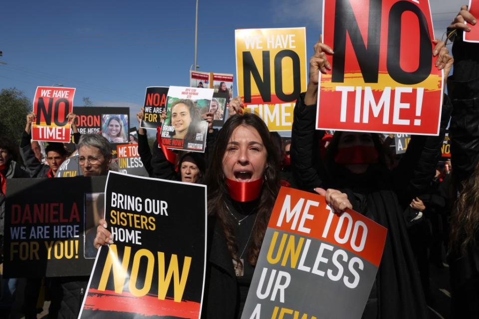 Relatives and friends of Israeli hostages held by Hamas since its October 7 attack in southern Israel, march near Kibbutz Orim. ACK GUEZ/AFP via Getty Images