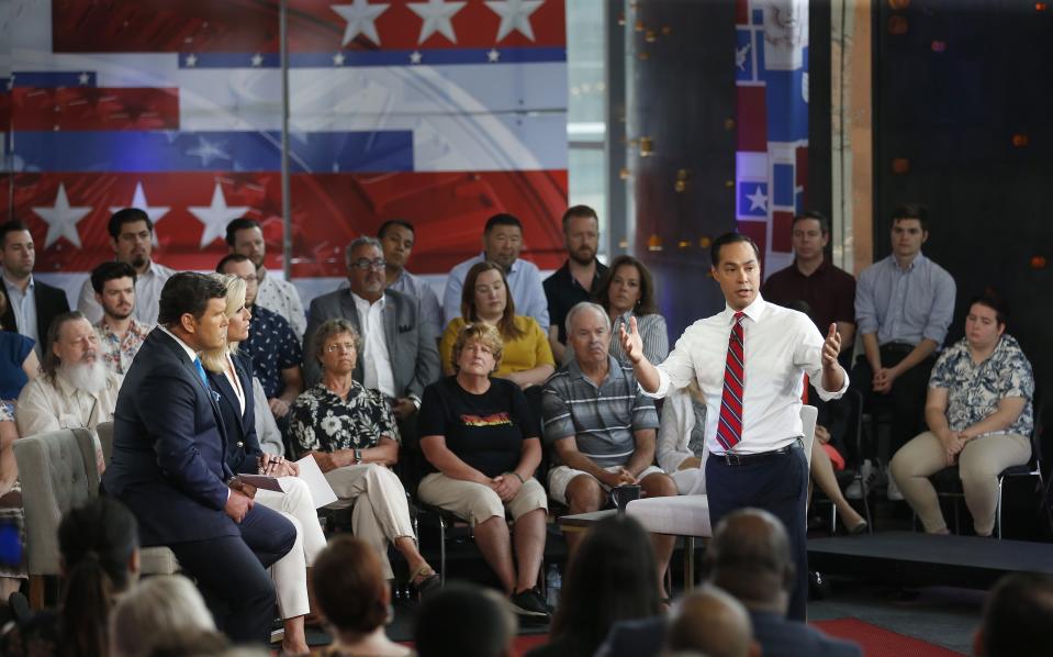 Democratic presidential candidate Julian Castro, right, answers a question during a FOX News Channel town hall event, Thursday, June 13, 2019, in Tempe, Ariz. Fox News anchors Bret Baier, left, and Martha MacCallum, second from left, listen to Castro's answer. (AP Photo/Ross D. Franklin)